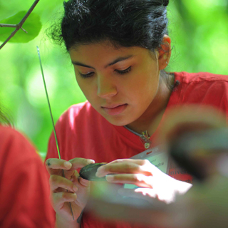 a student studying a plant